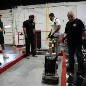 Instructor demonstrates a Rhino grinder to students during training