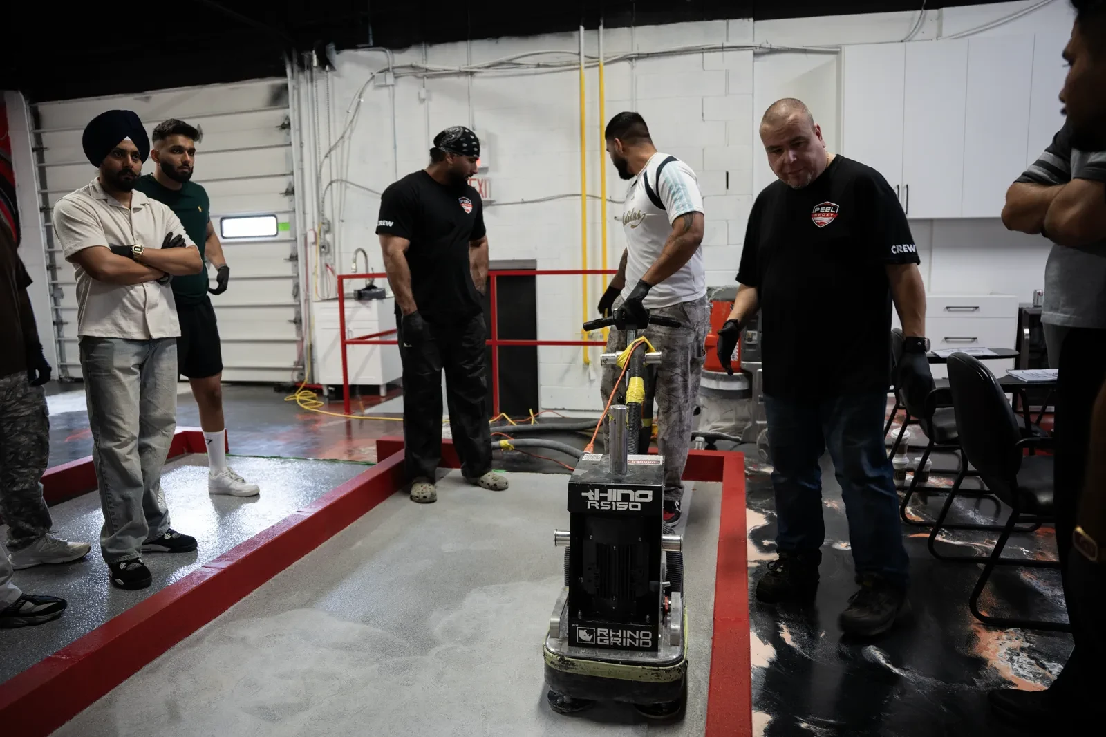 Instructor demonstrates a Rhino grinder to students during training